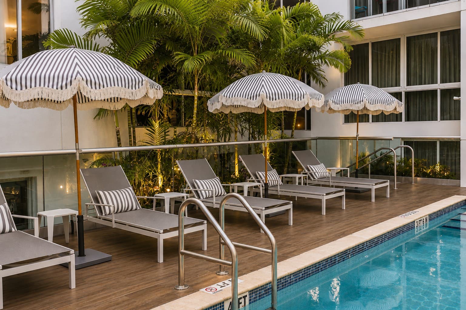 Pool deck with striped umbrellas